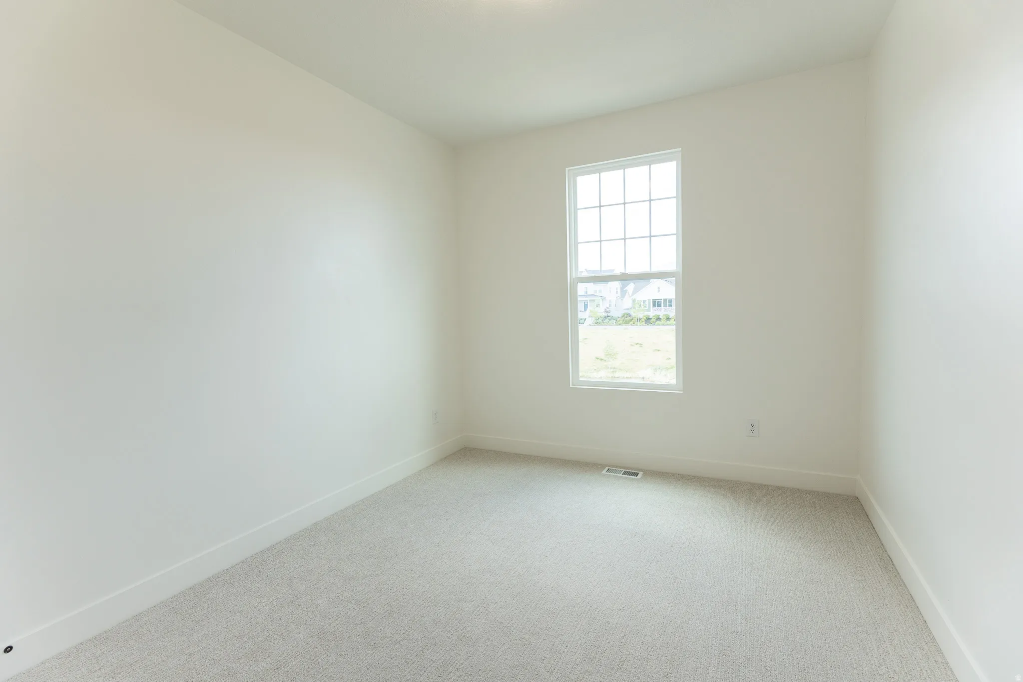 Neutral-toned carpeting and white walls create a blank canvas
