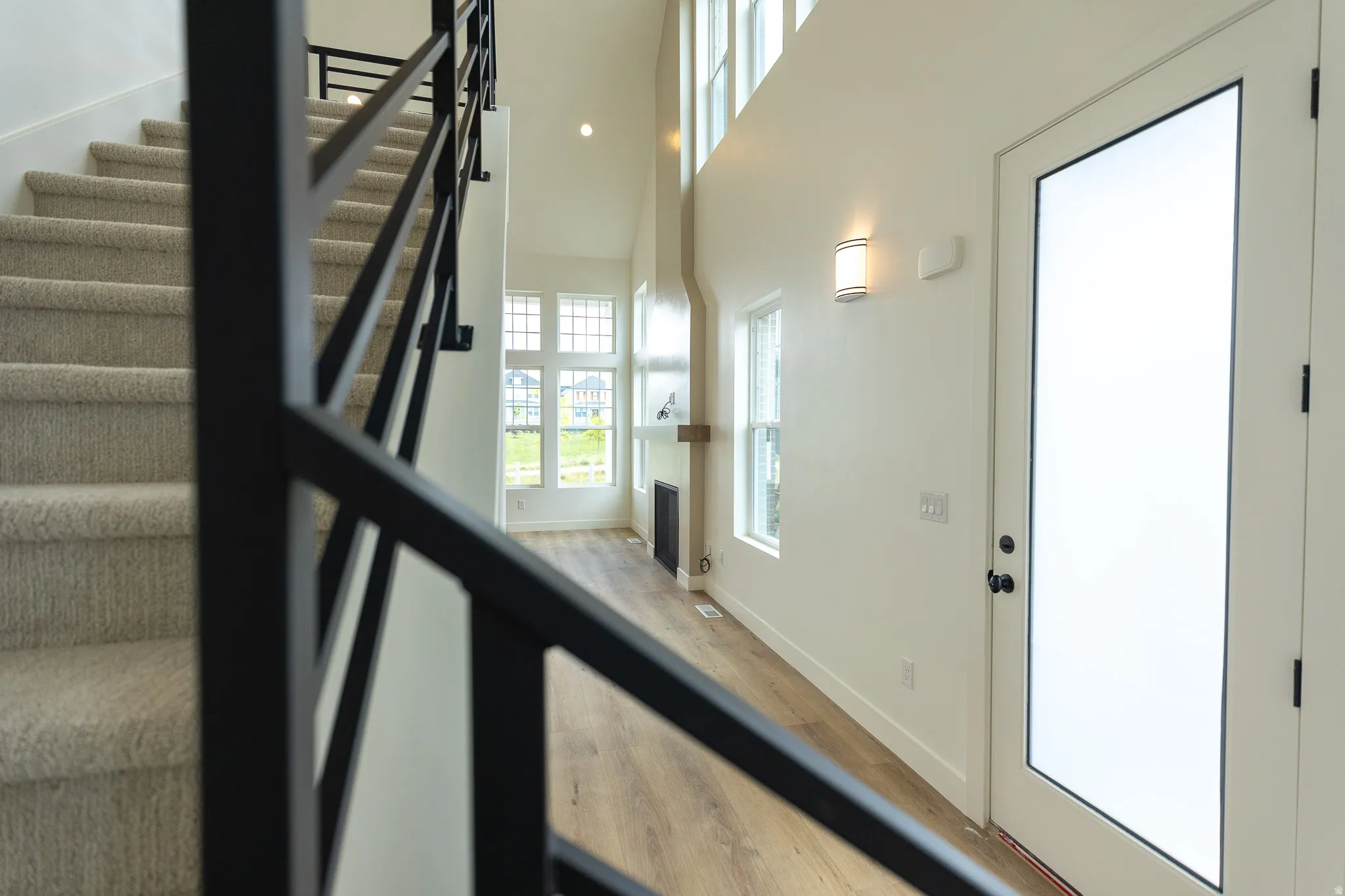 Open-concept living area with soaring ceilings and abundant natural light