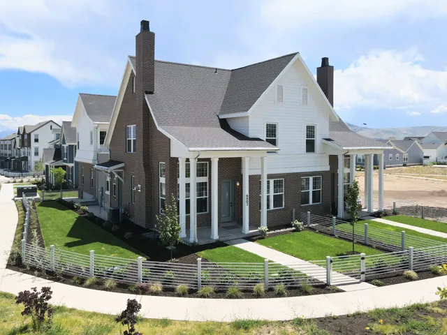 Distinguished brick and white siding exterior with a dark roof