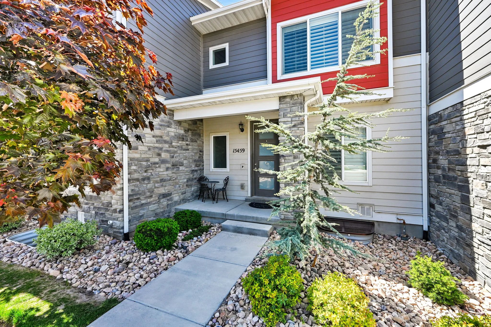 Modern townhouse exterior featuring stone veneer siding and horizontal panel siding