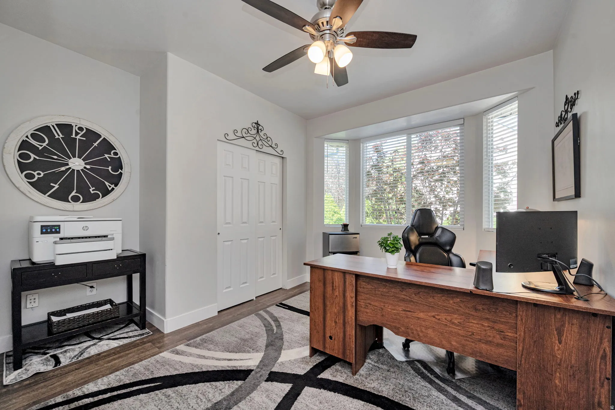 Recessed lighting, wood-finish flooring, and a ceiling fan with integrated lighting