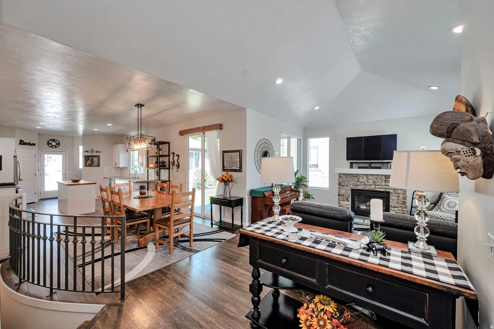 Open-concept living area with vaulted ceilings and recessed lighting