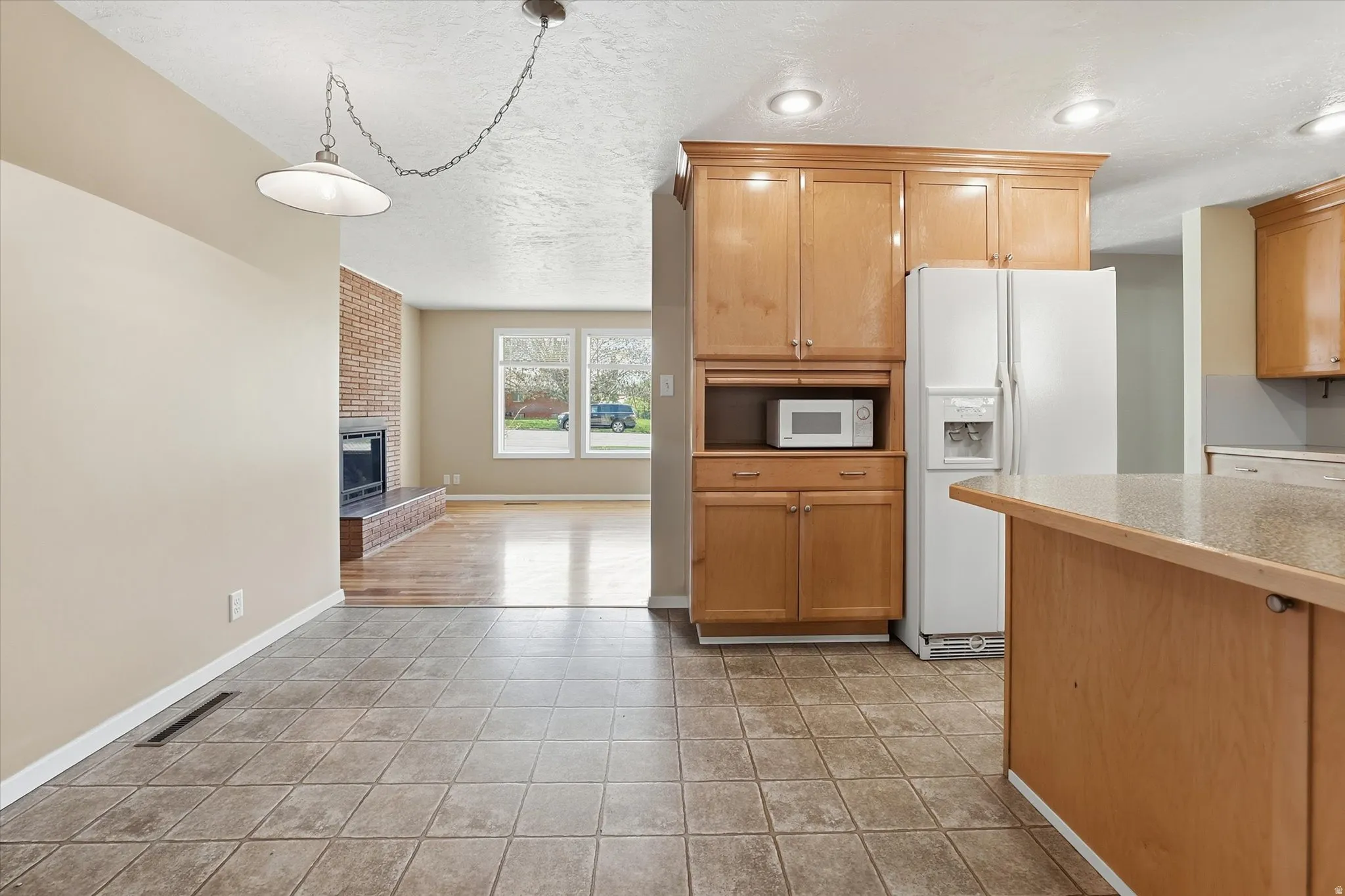 Kitchen featuring light wood cabinetry, recessed lighting, and a neutral tile floor