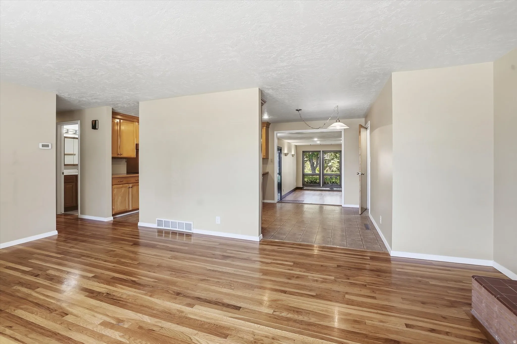 Spacious interior featuring wood-finish flooring, neutral wall tones, and recessed lighting