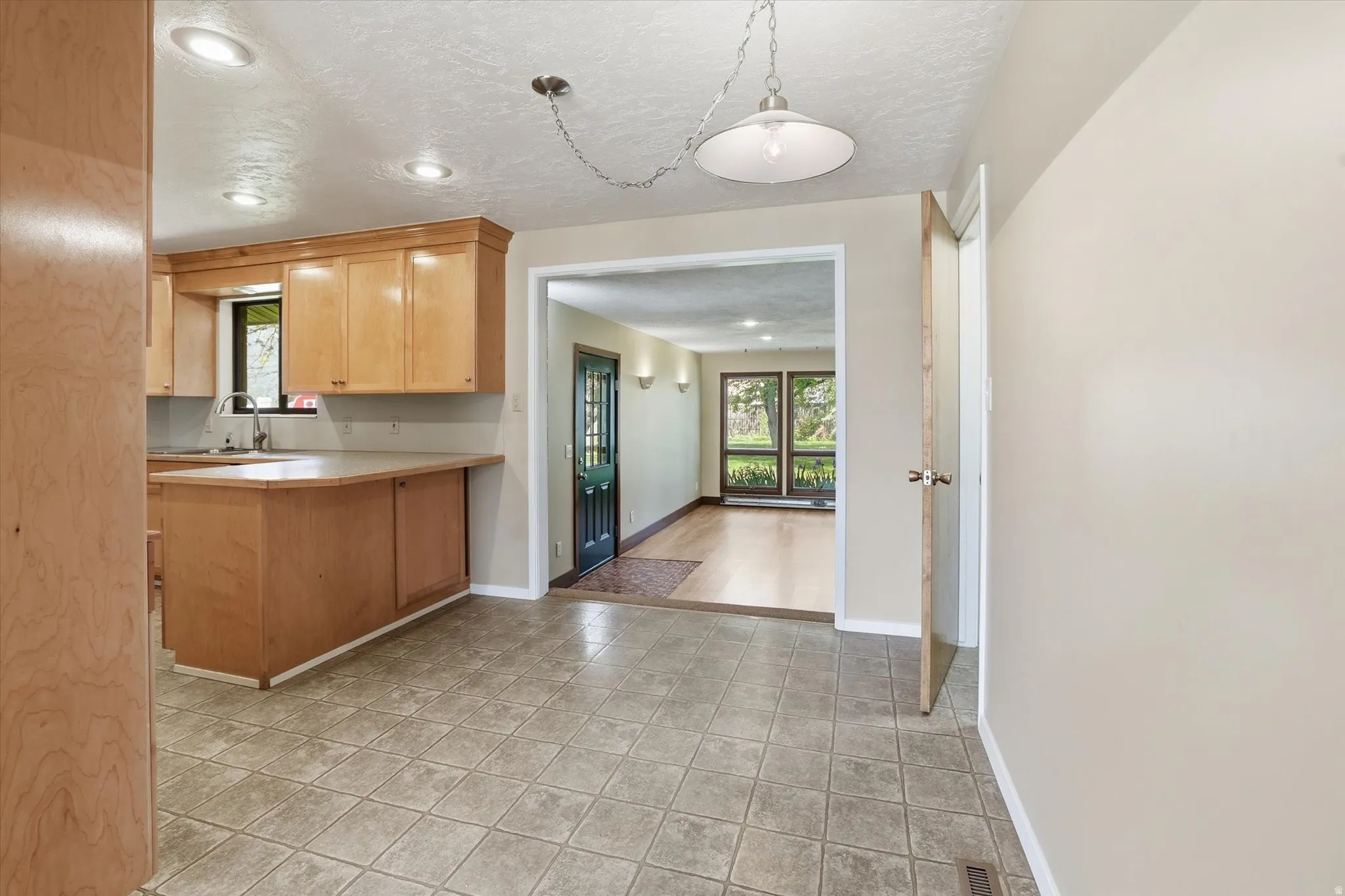 Kitchen area featuring wood cabinetry, recessed lighting, and a peninsula countertop