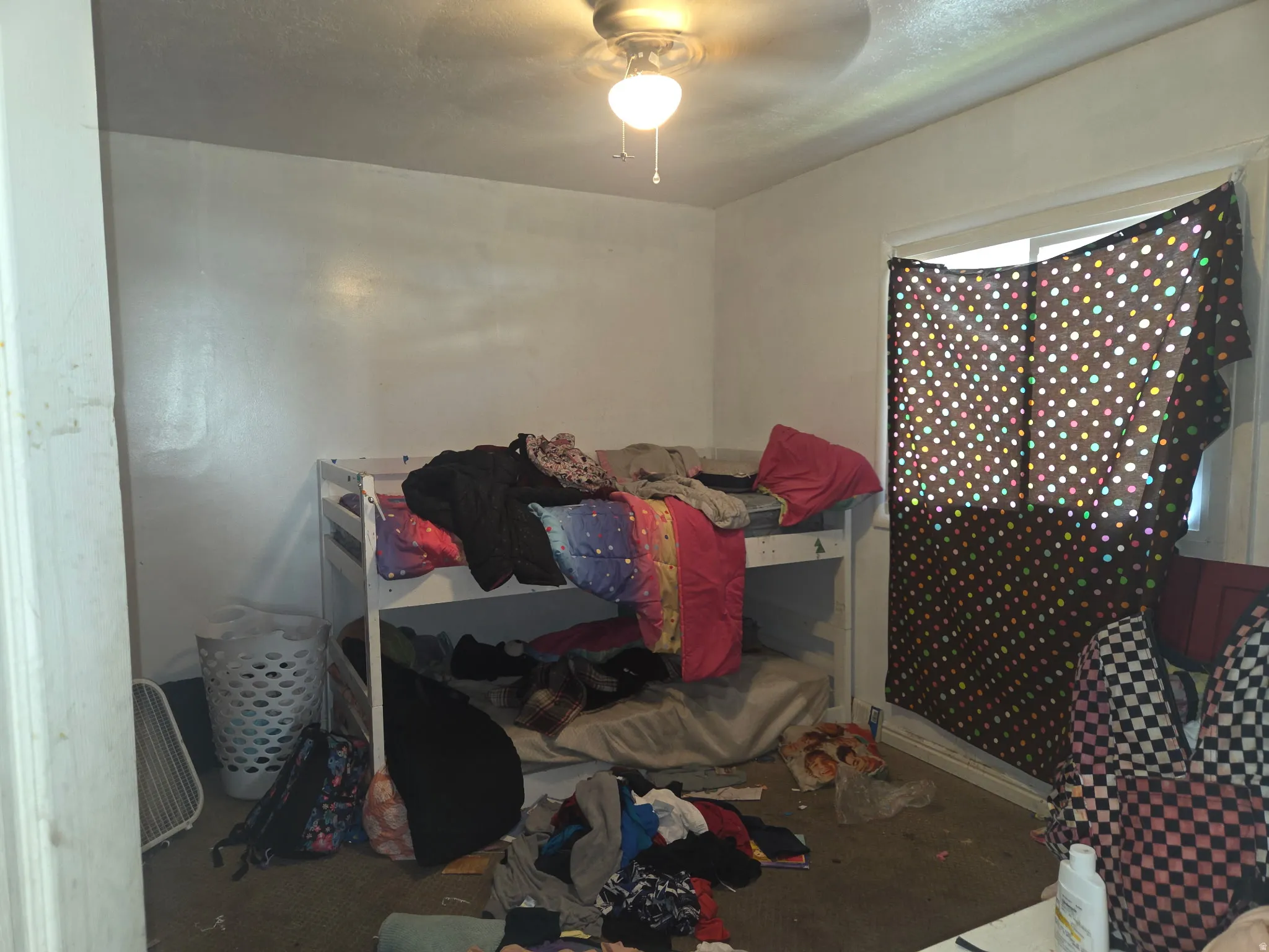 Room with a ceiling fan light fixture and a window