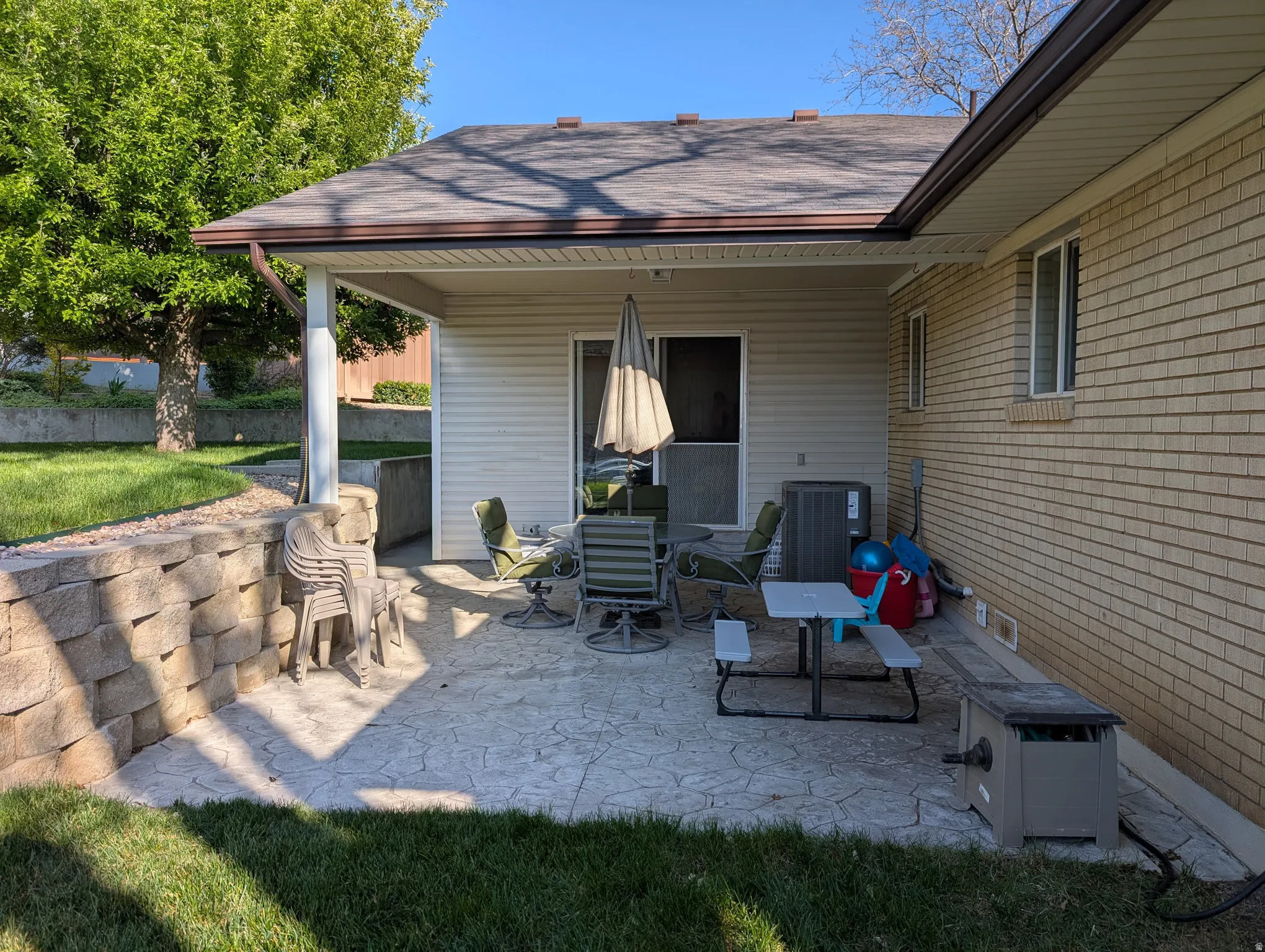 Covered stamped concrete patio with direct outdoor access