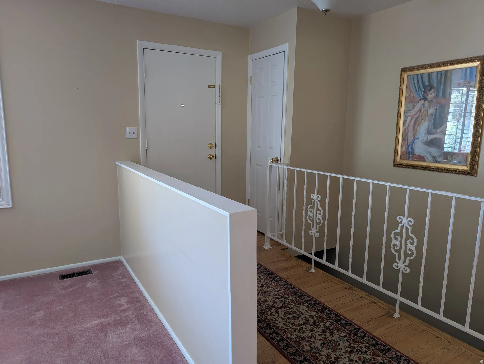 Front door with half-wall separating the living room from the entry