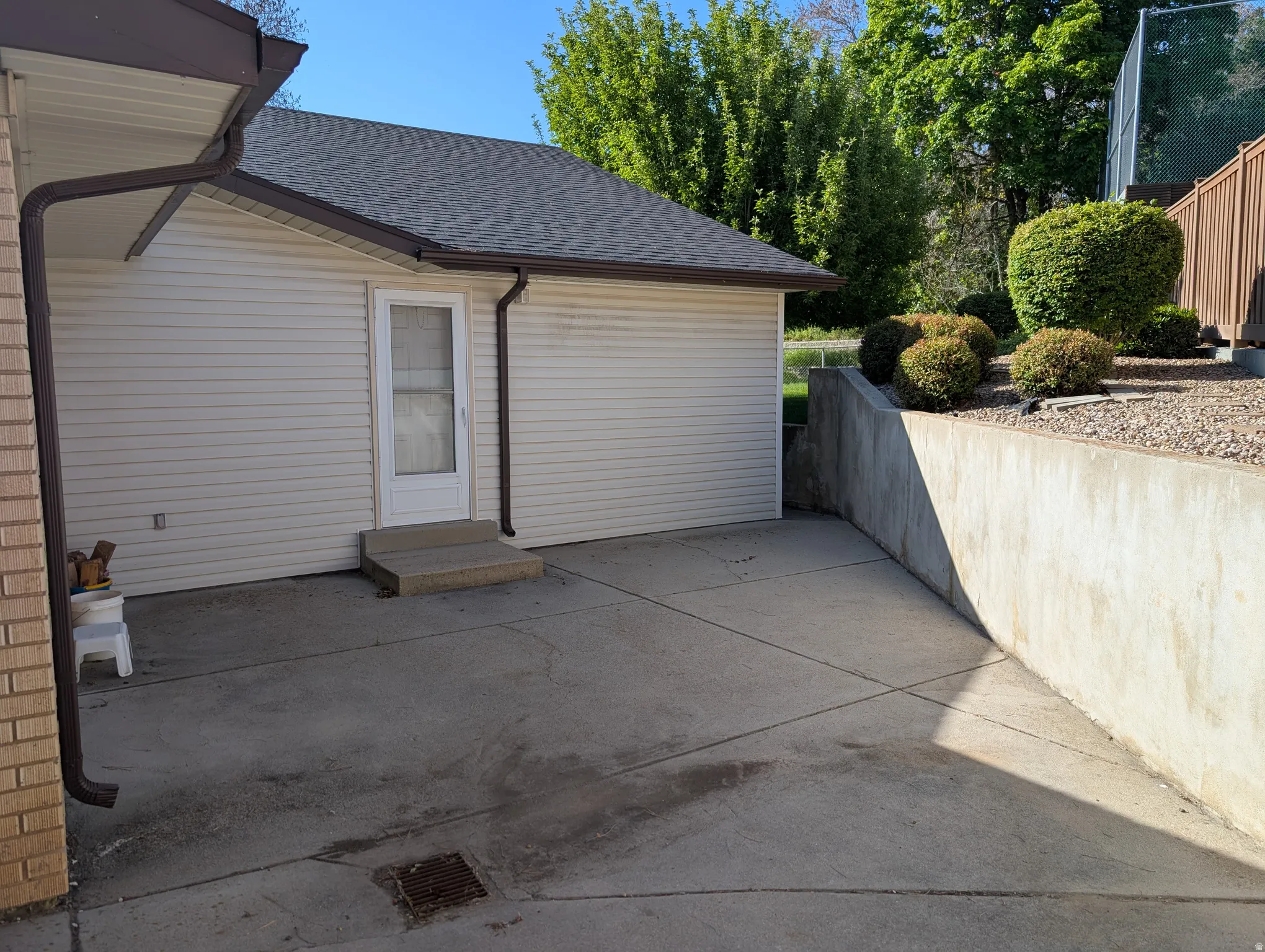 Concrete patio area featuring a retaining wall