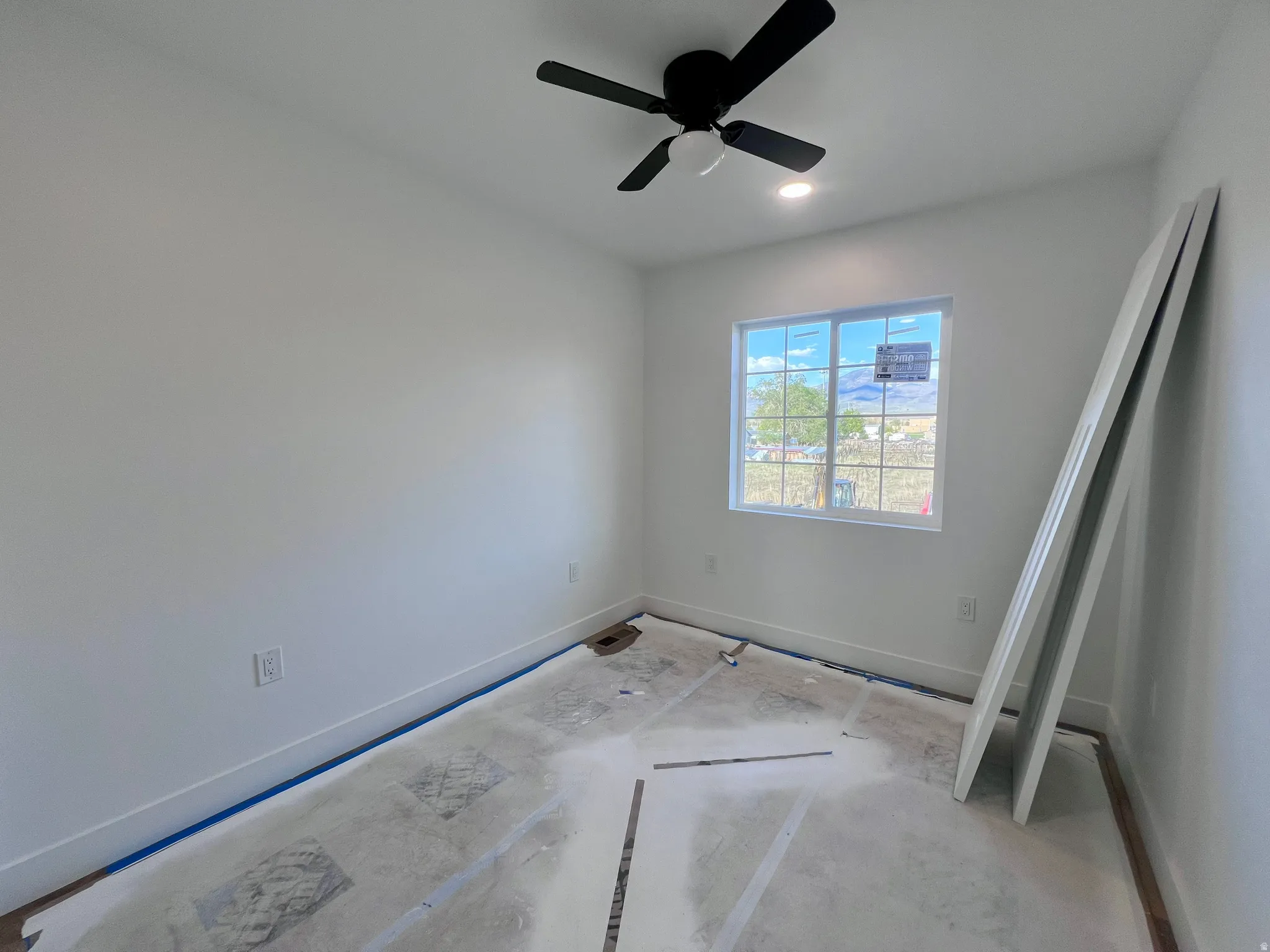 Room featuring a white ceiling, recessed lighting, and a black ceiling fan