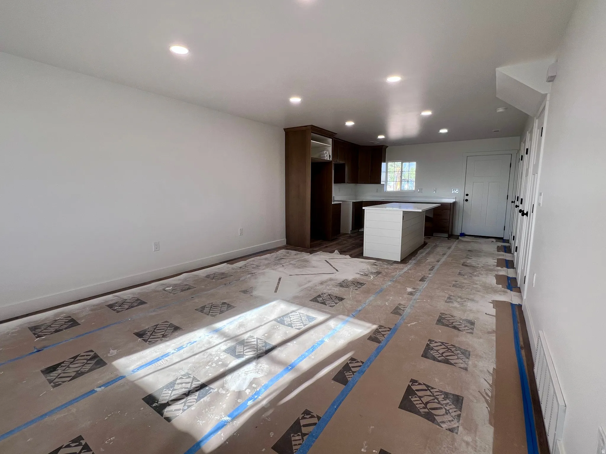 Open-concept living space with recessed lighting and neutral wall tones