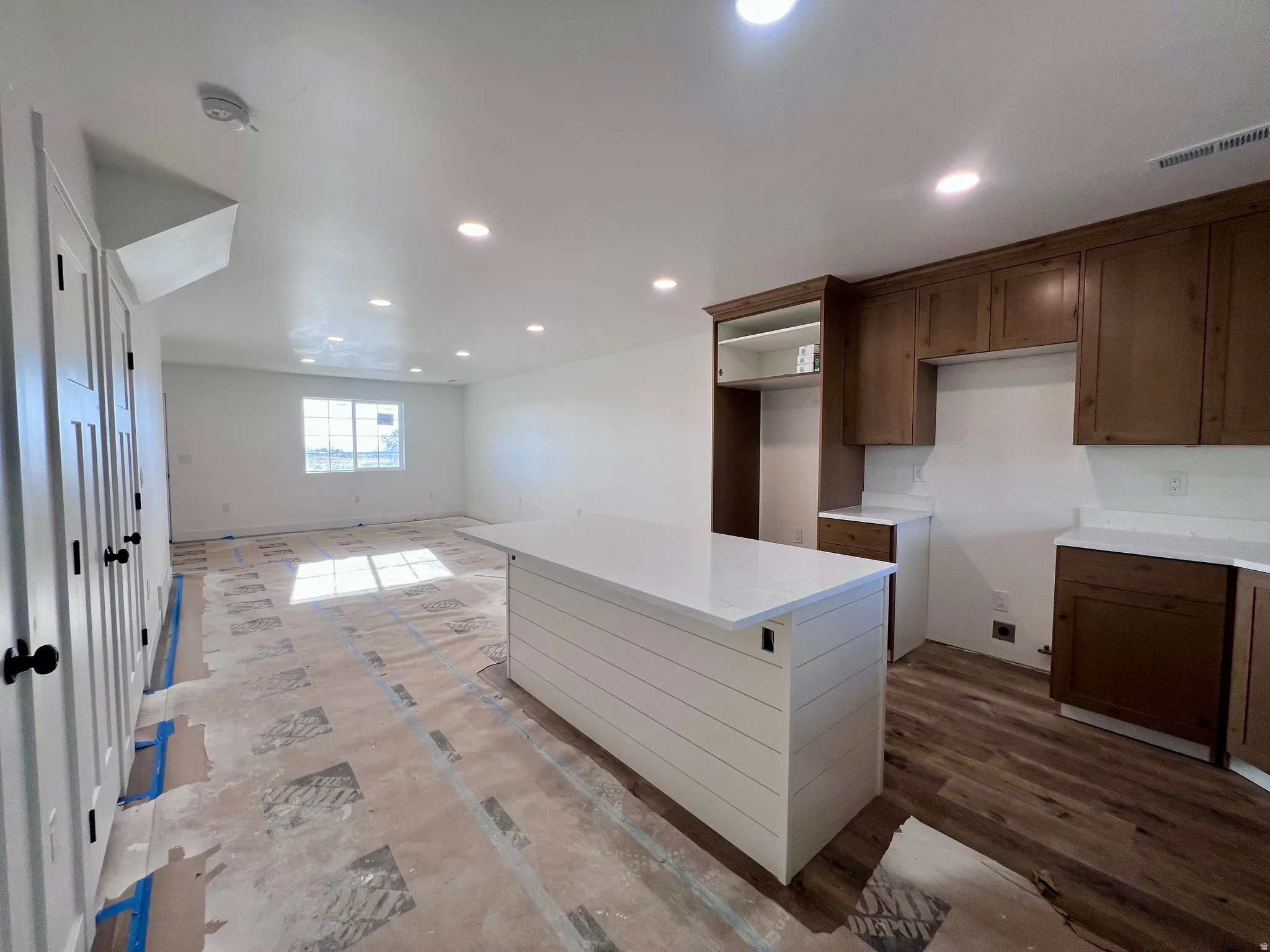Kitchen island with shiplap-style paneling and a light-toned countertop