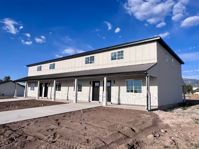 Multi-unit property with a metal roof and stone veneer accents