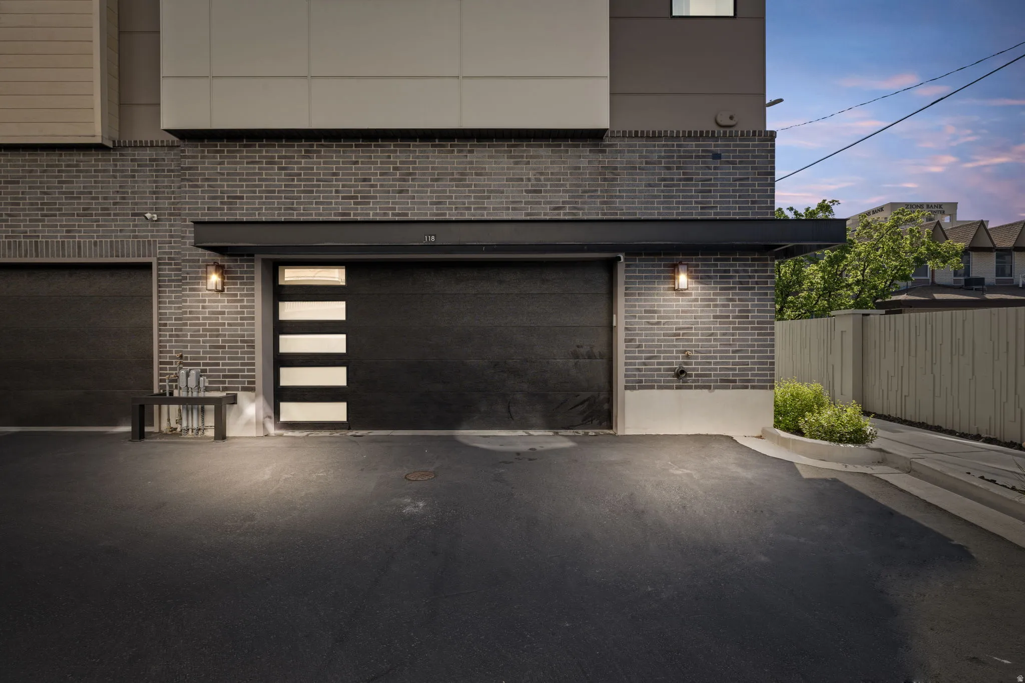 Garage featuring asphalt driveway