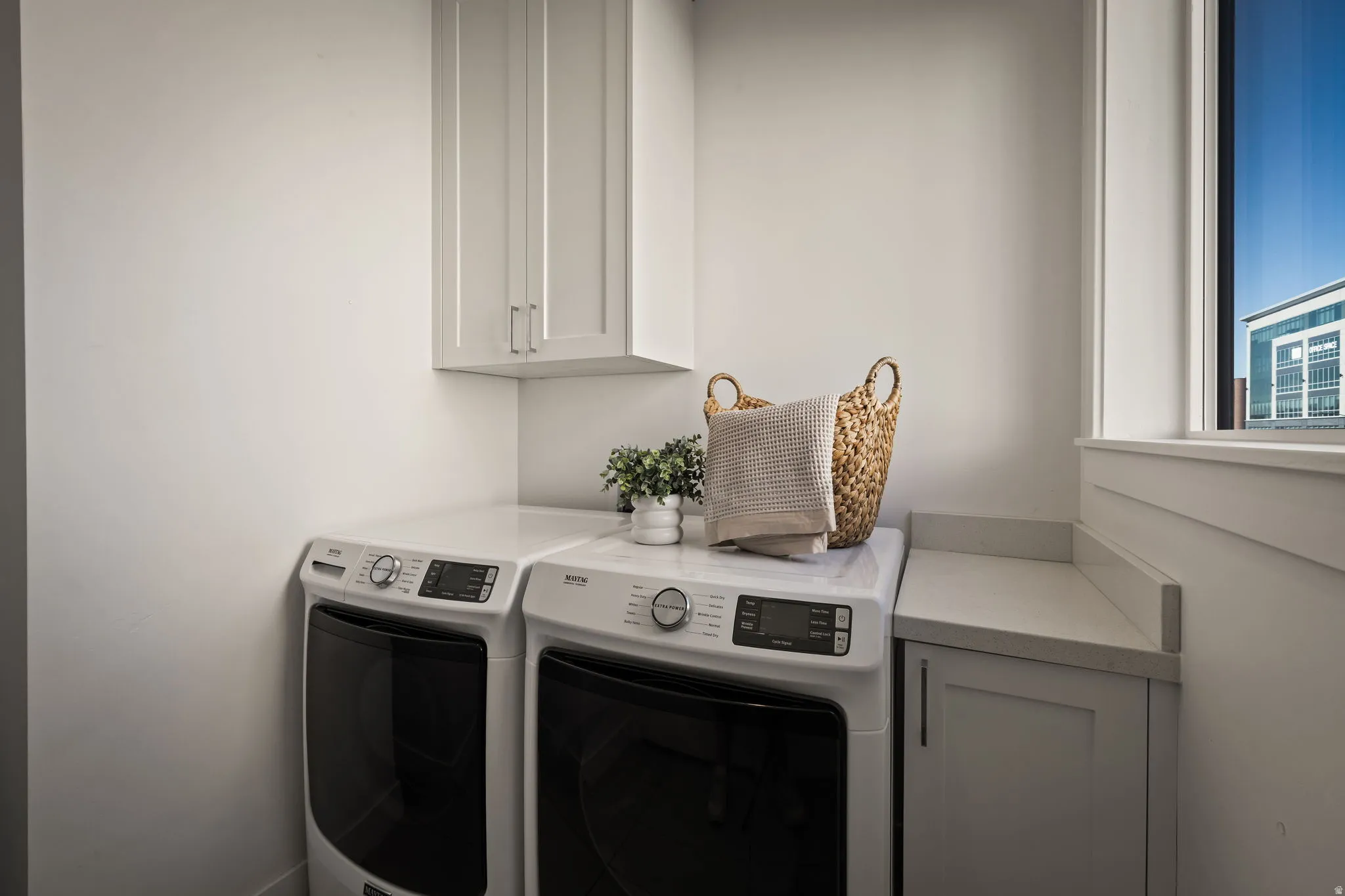 Laundry room with cabinet space and washing machine and dryer