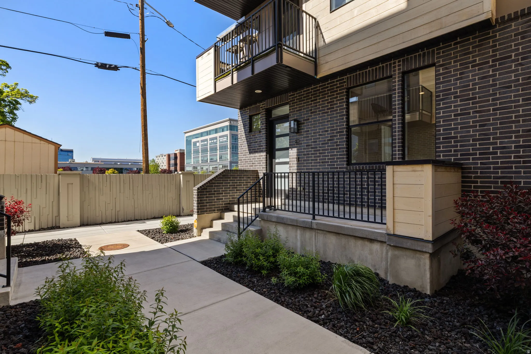 View of exterior entry with brick siding and covered porch