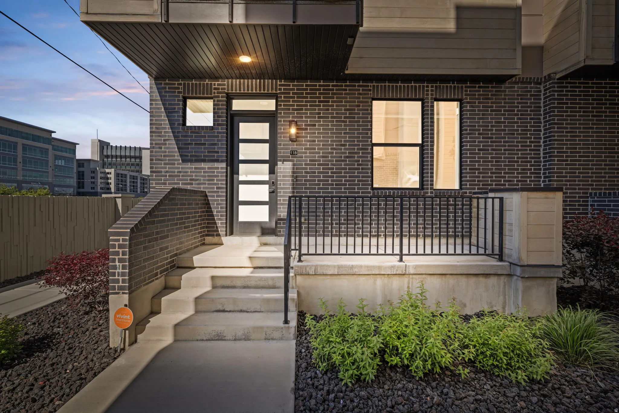 Exterior entry at dusk featuring brick siding