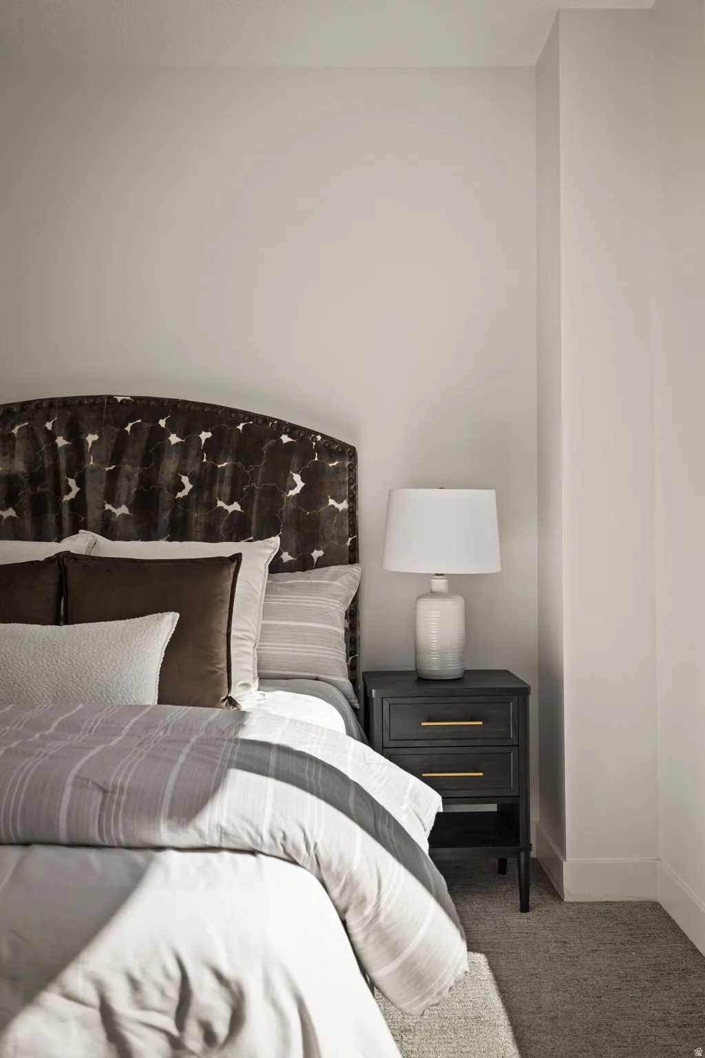 Bedroom featuring carpet and baseboards