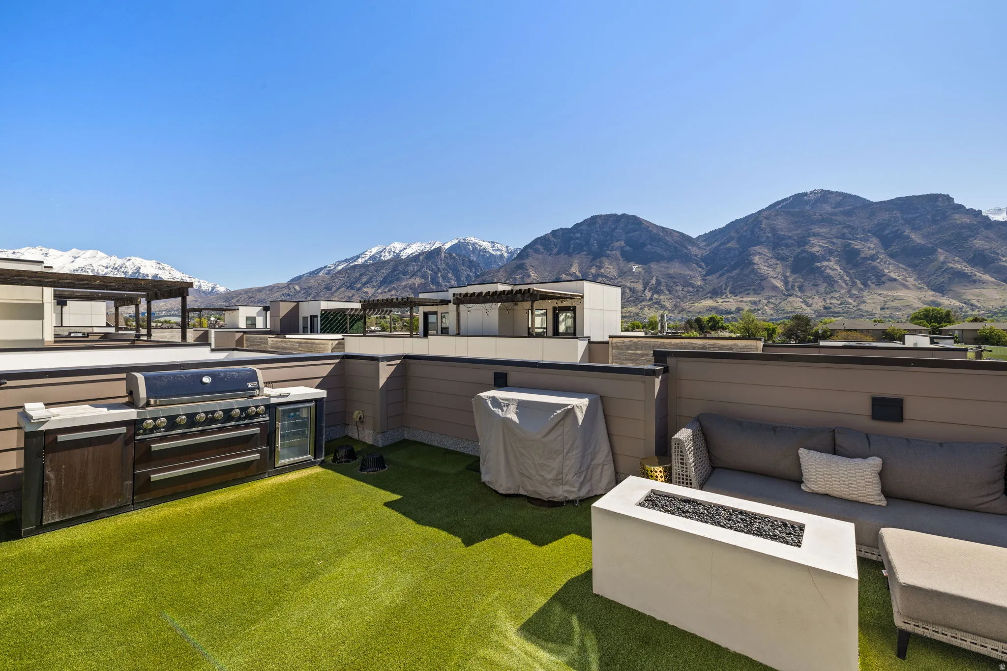 View of patio / terrace with a mountain view, grilling area, and an outdoor living space with a fire pit