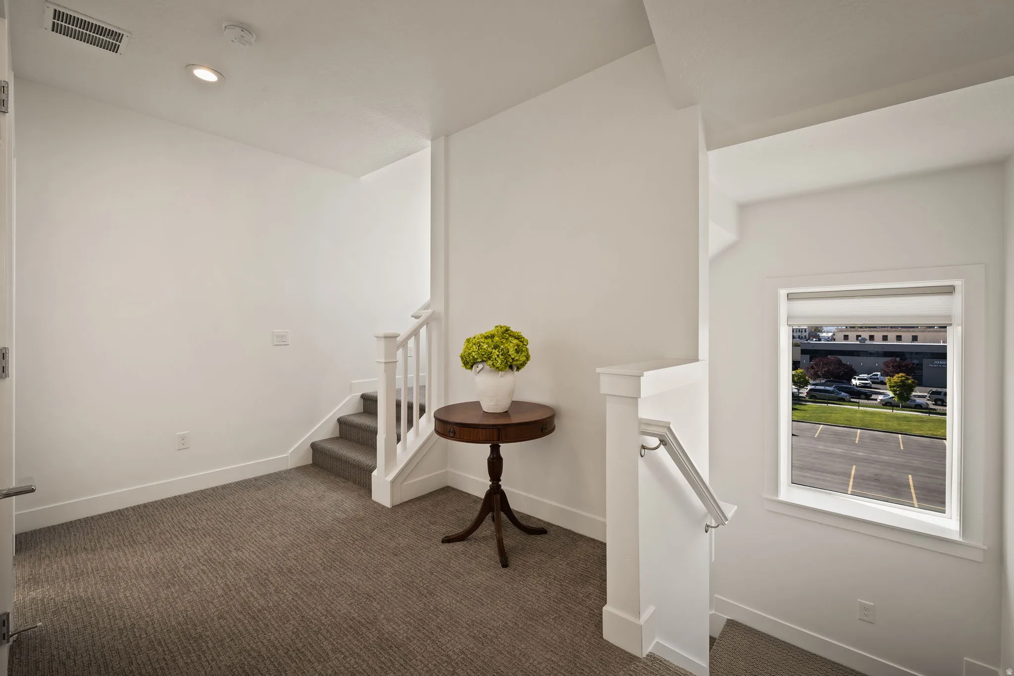 Staircase with carpet flooring and recessed lighting