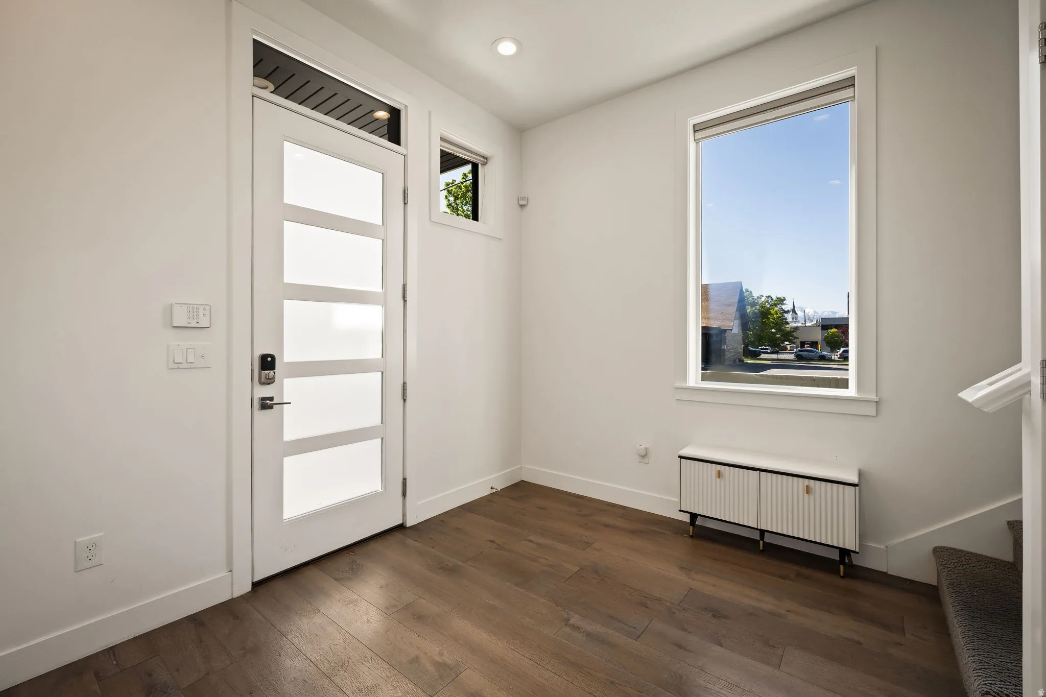 Foyer featuring radiator heating unit and dark wood finished floors