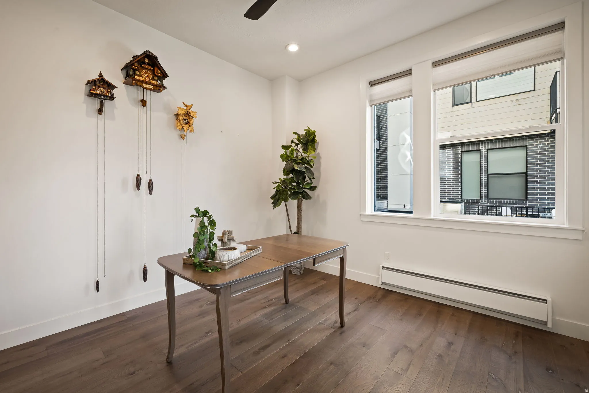 Home office featuring baseboard heating, dark wood-type flooring, ceiling fan, and recessed lighting