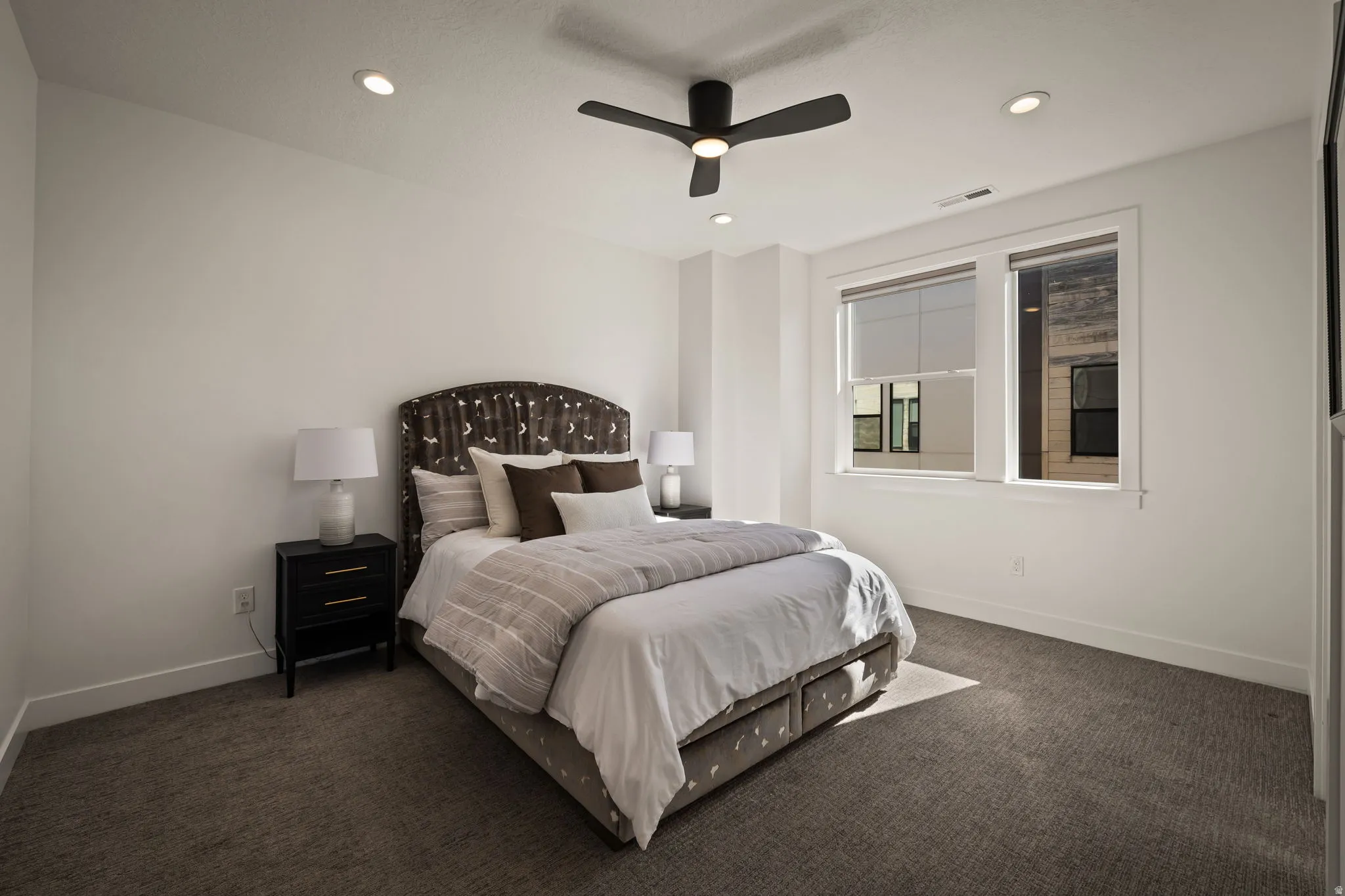 Bedroom featuring dark carpet, recessed lighting, and ceiling fan