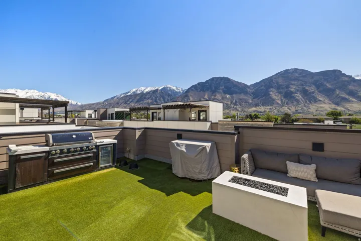 View of patio / terrace with a mountain view, grilling area, and an outdoor living space with a fire pit
