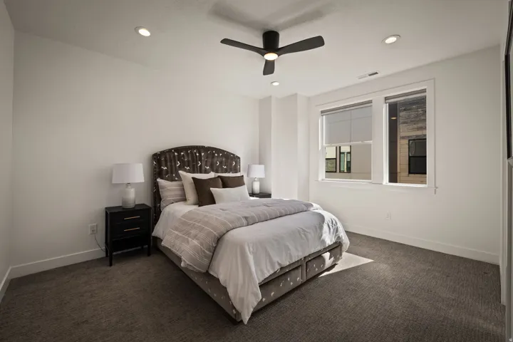 Bedroom featuring dark carpet, recessed lighting, and ceiling fan