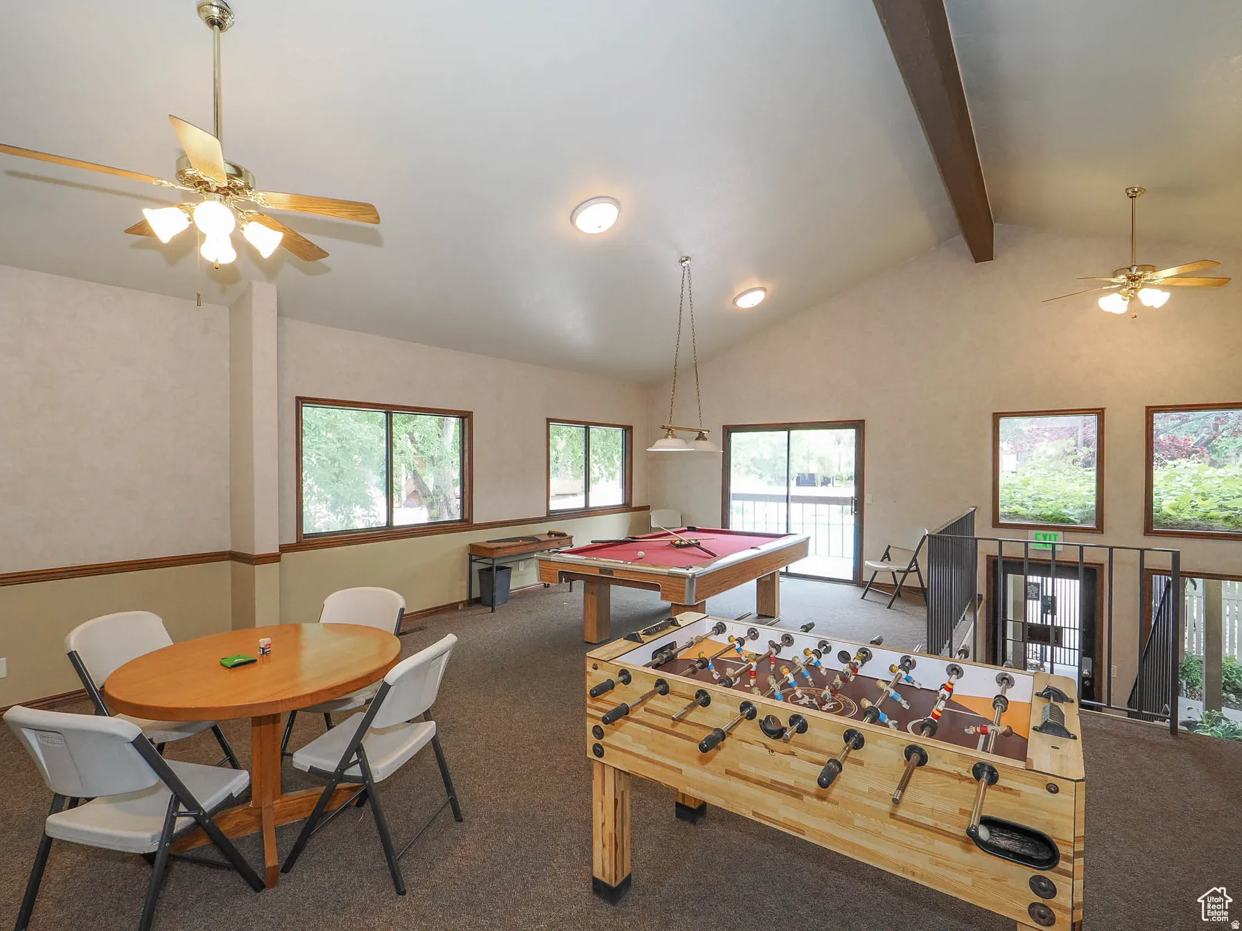 Spacious common area featuring vaulted ceilings, recessed lighting, and ceiling fans
