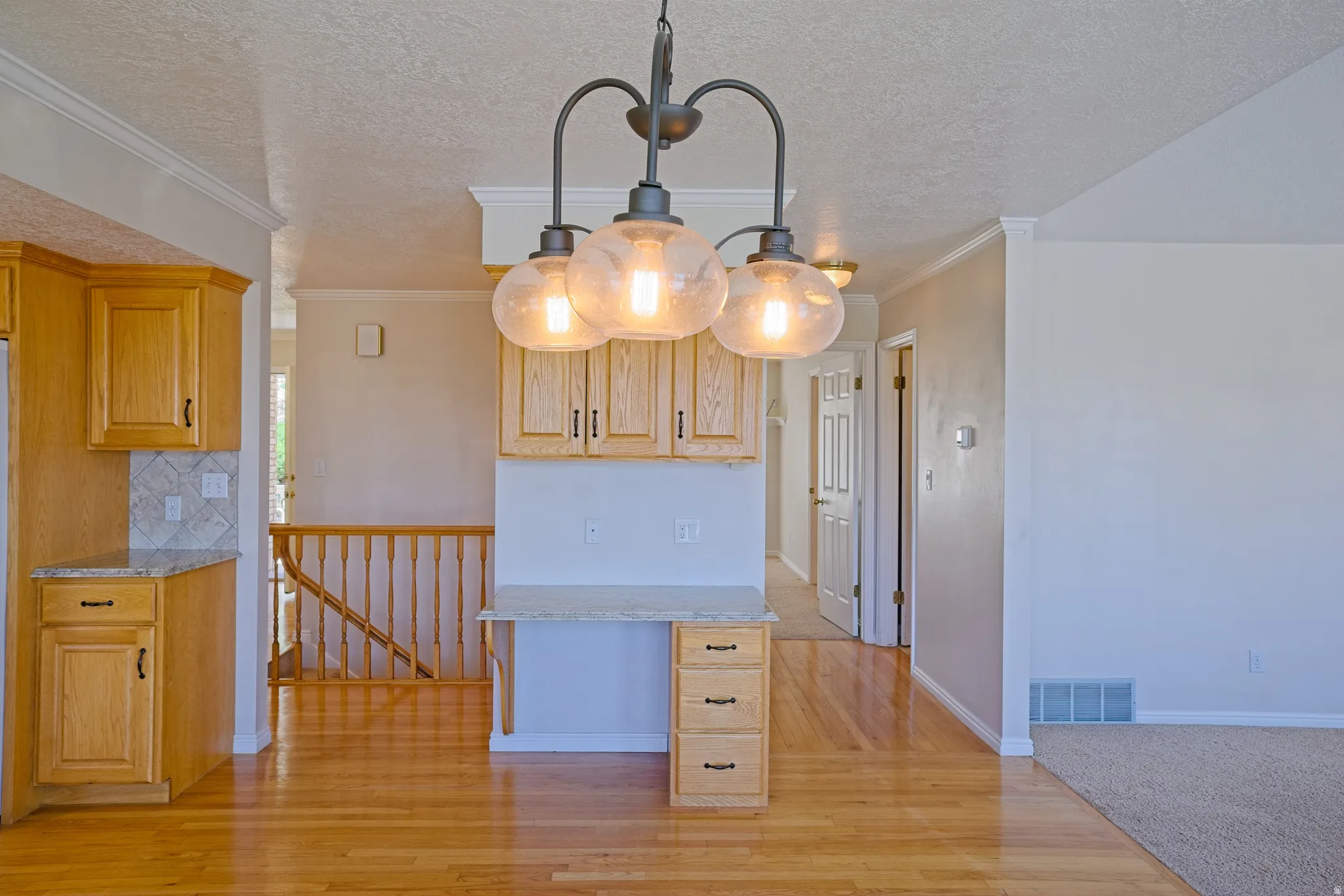 Kitchen and dining area featuring warm wood-finish flooring