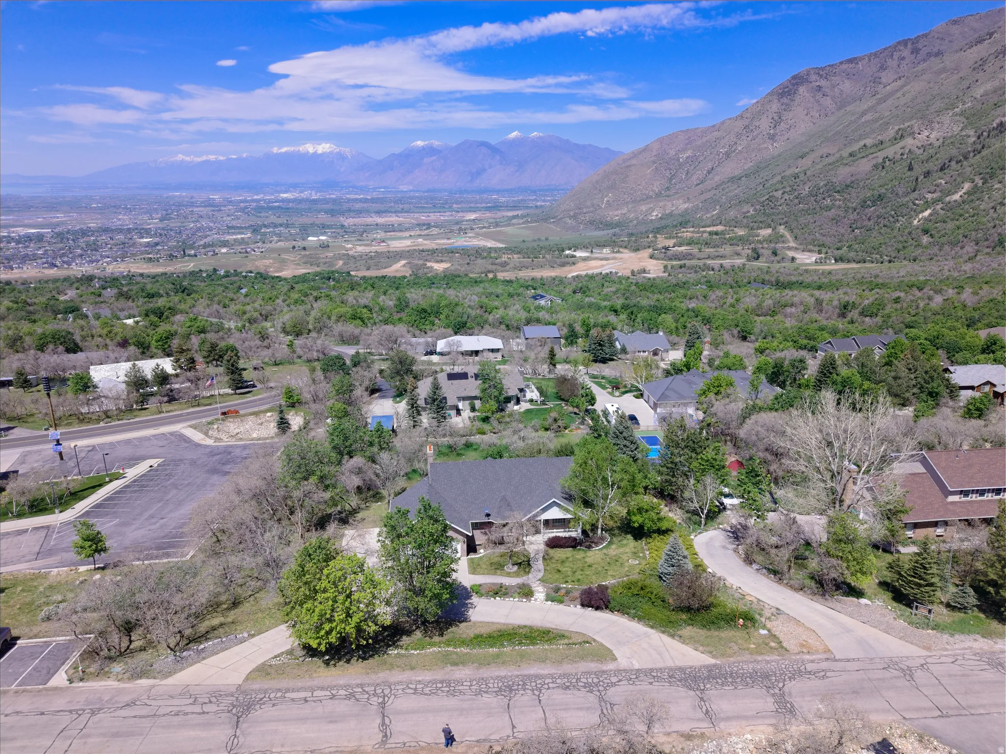 Expansive property featuring a mountain backdrop and surrounding green landscape
