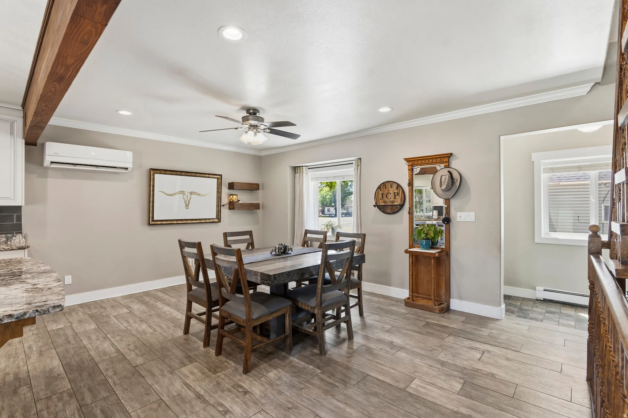 Dining area featuring wood-finish flooring and crown molding