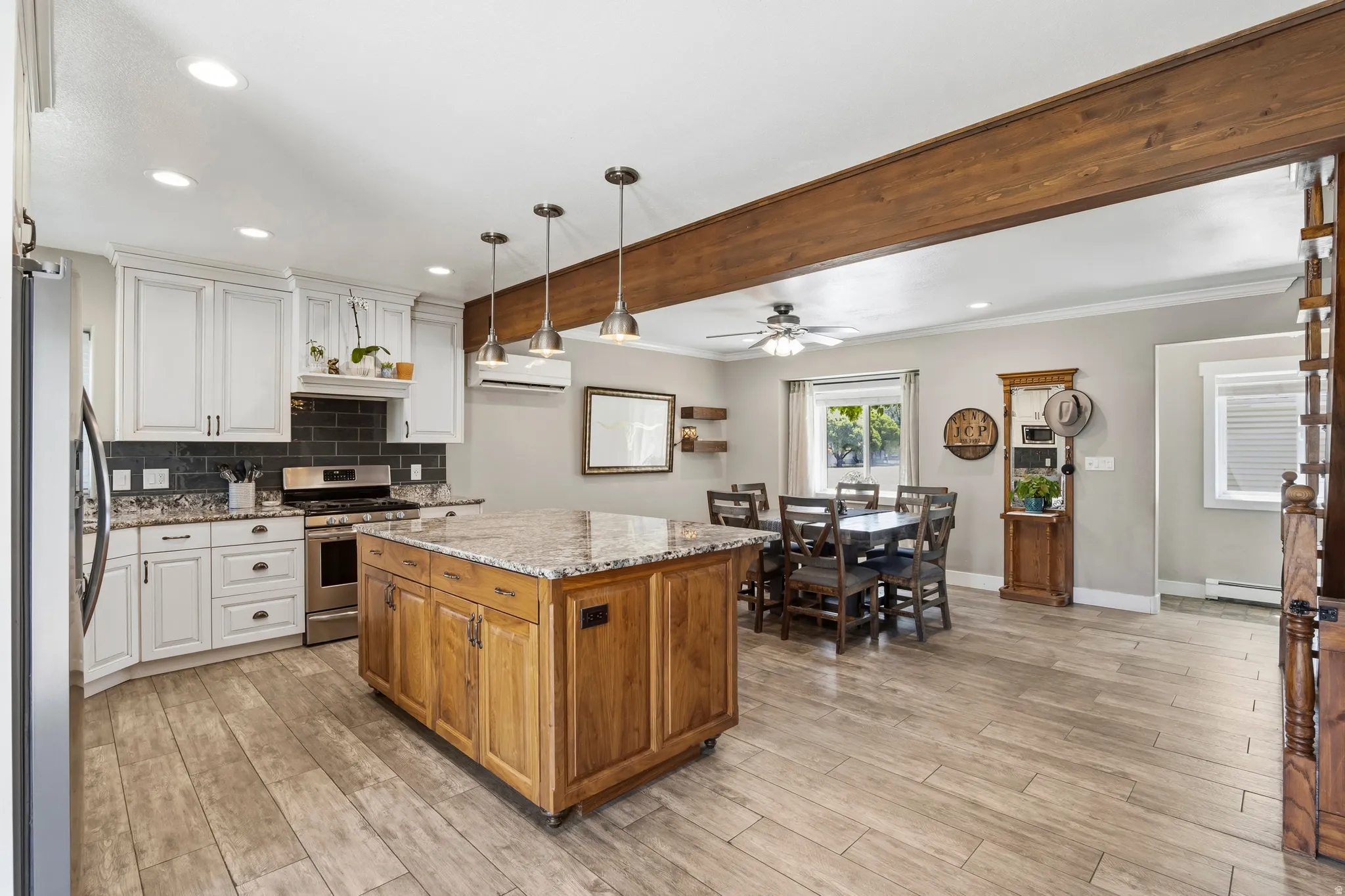 Kitchen featuring white cabinetry, granite countertops, and a dark tile backsplash