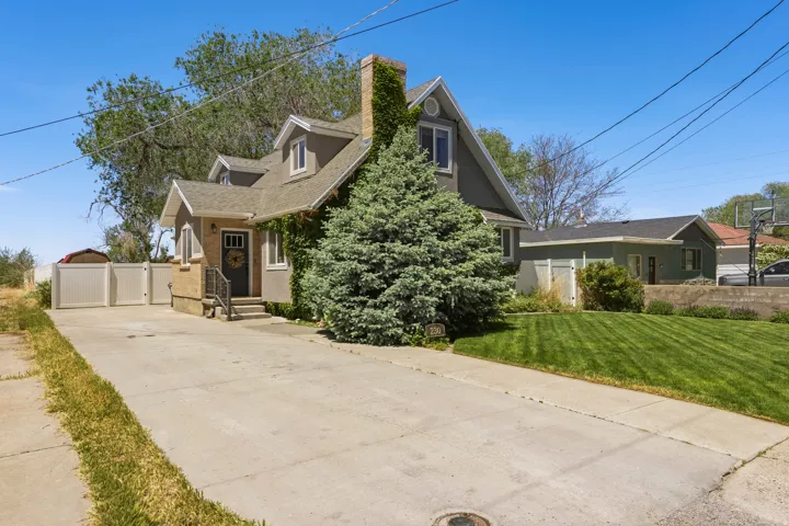 Traditional-style residence featuring a stucco and brick exterior with dormer windows