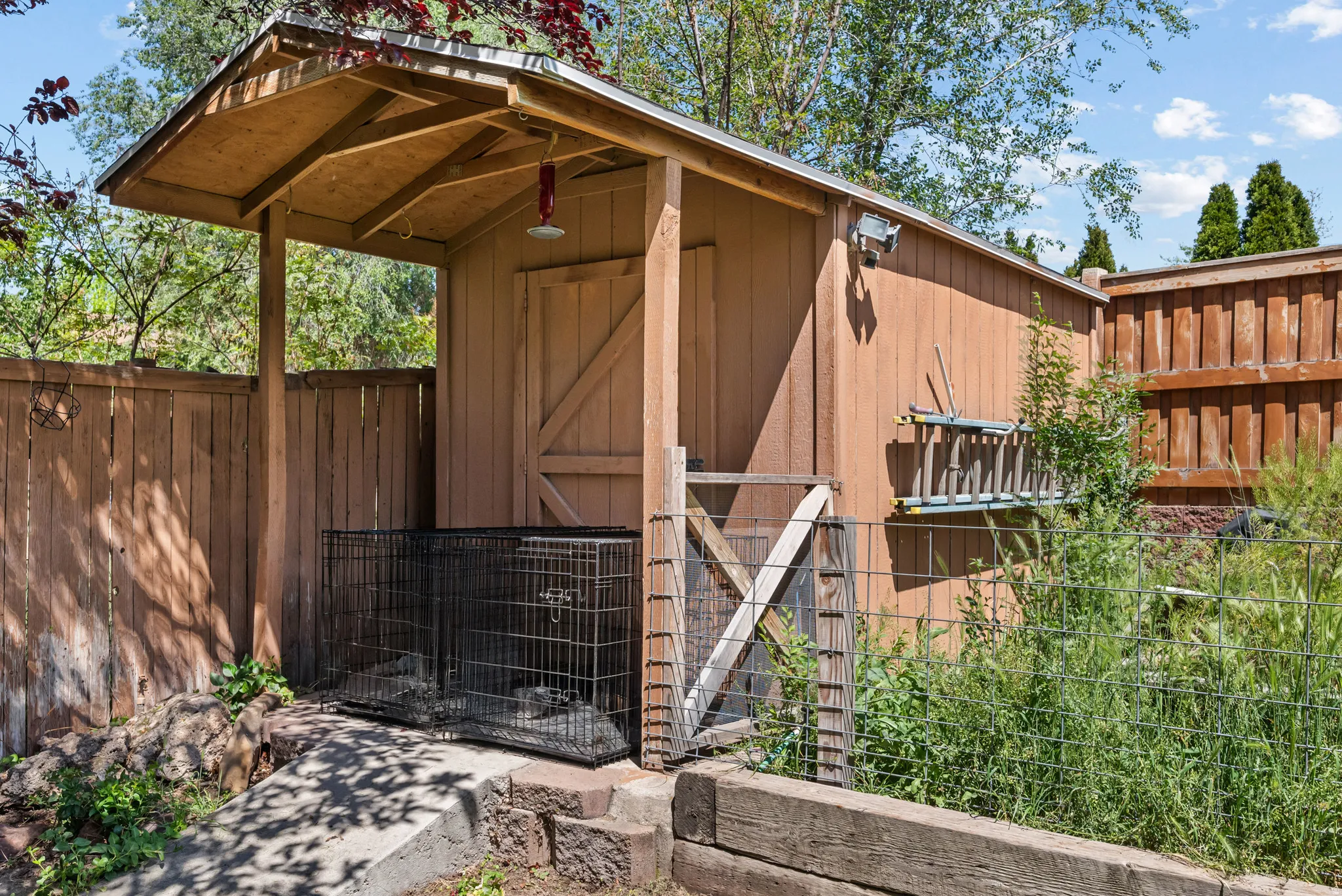 Wood-sided shed with a covered entry and a board-and-batten style door