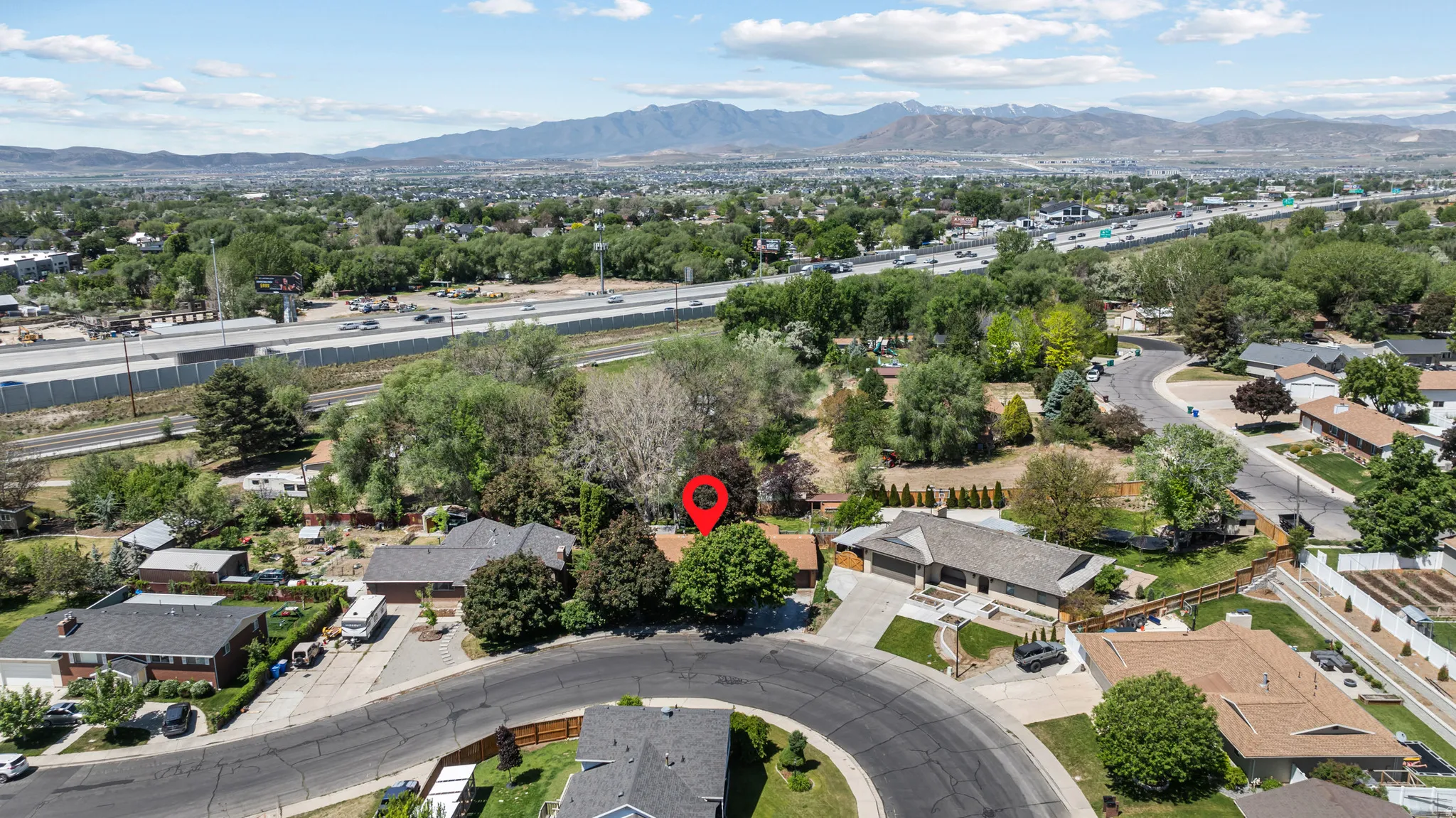 Aerial perspective of a suburban neighborhood featuring residential properties with mature landscaping