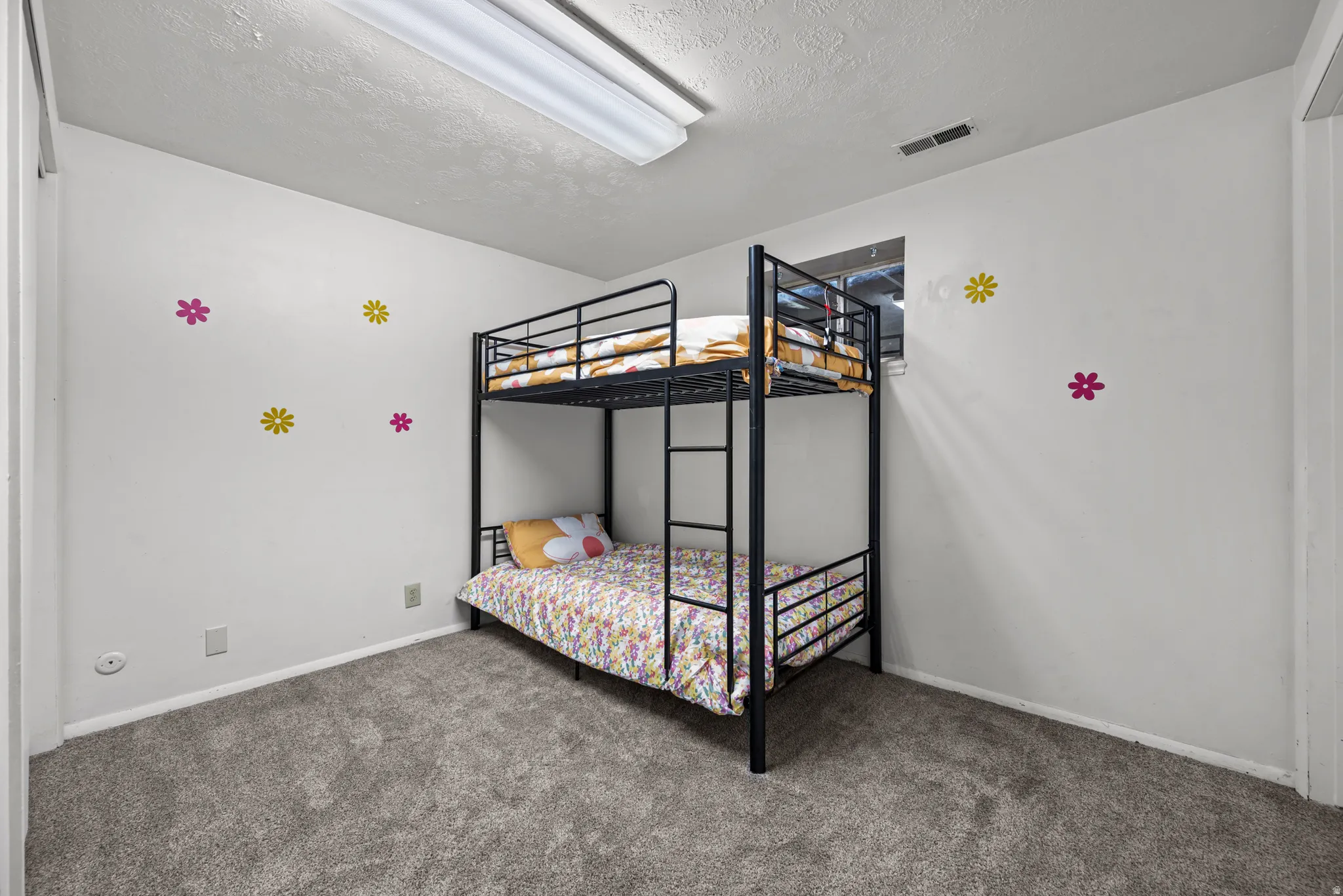 Carpeted room featuring a single window and white painted walls