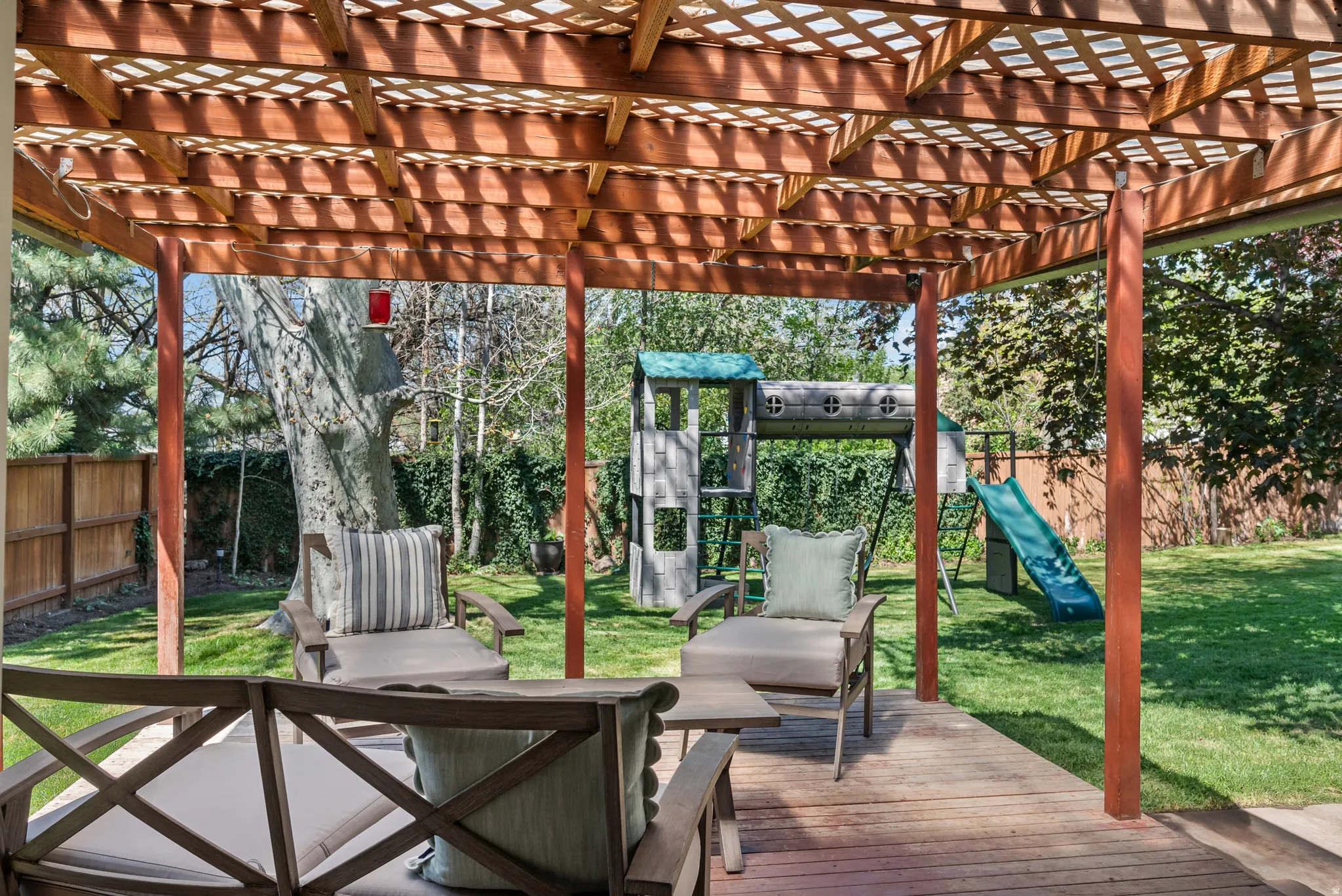 Wood pergola with lattice roof over a spacious deck