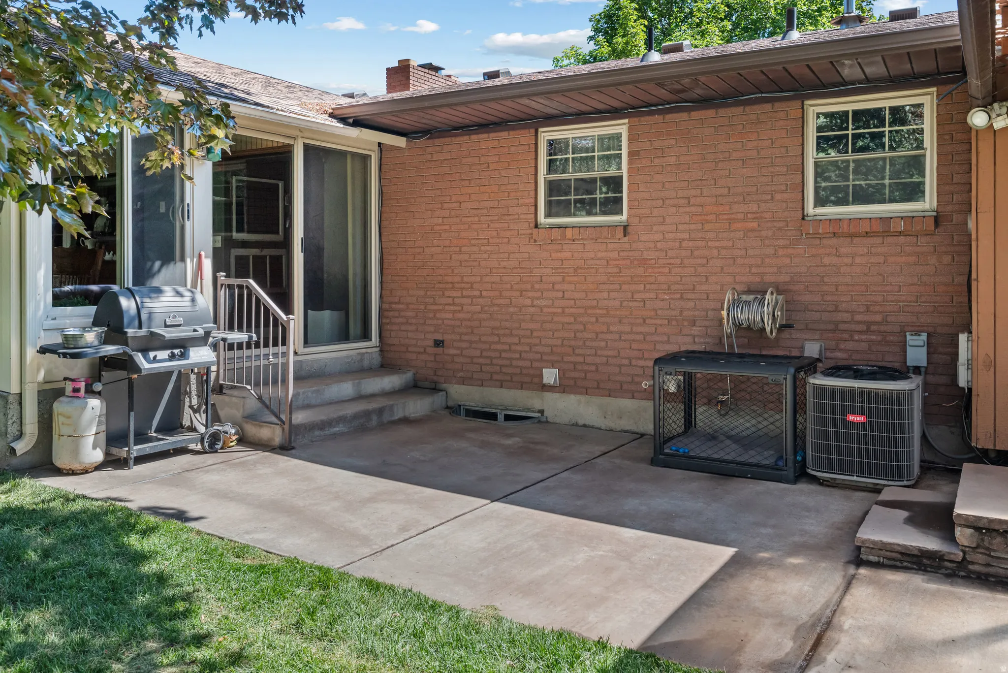 Patio area featuring concrete surfacing and direct access to interior spaces via a sliding glass door