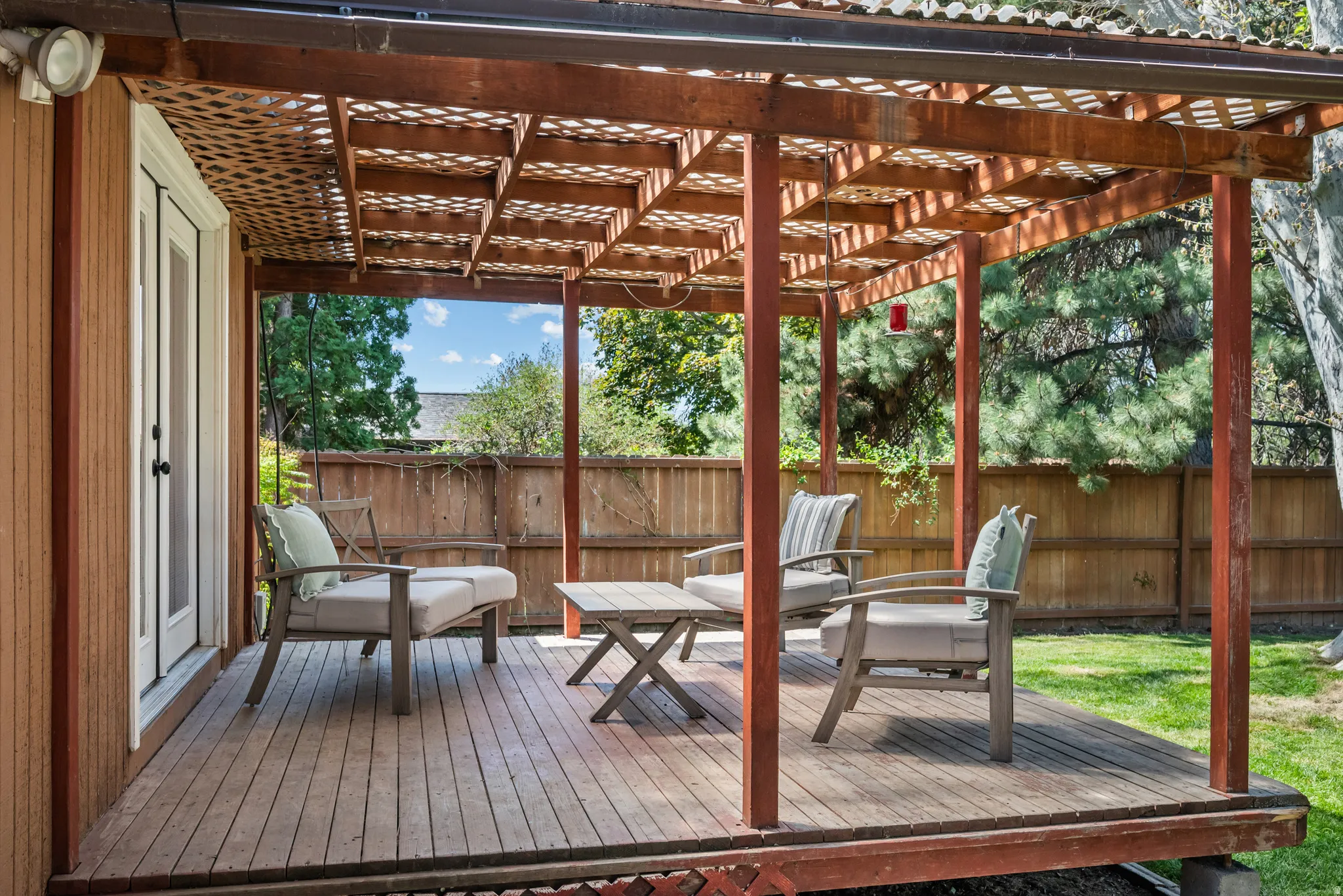 Wood-finish deck with a latticed pergola structure