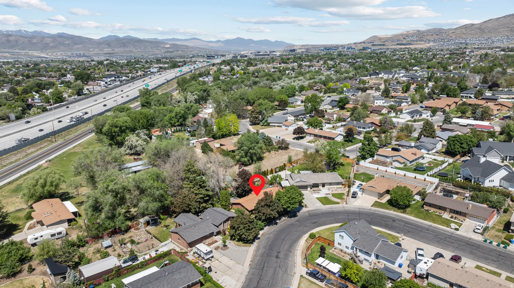 Residential property situated on a cul-de-sac, featuring mature trees and established landscaping