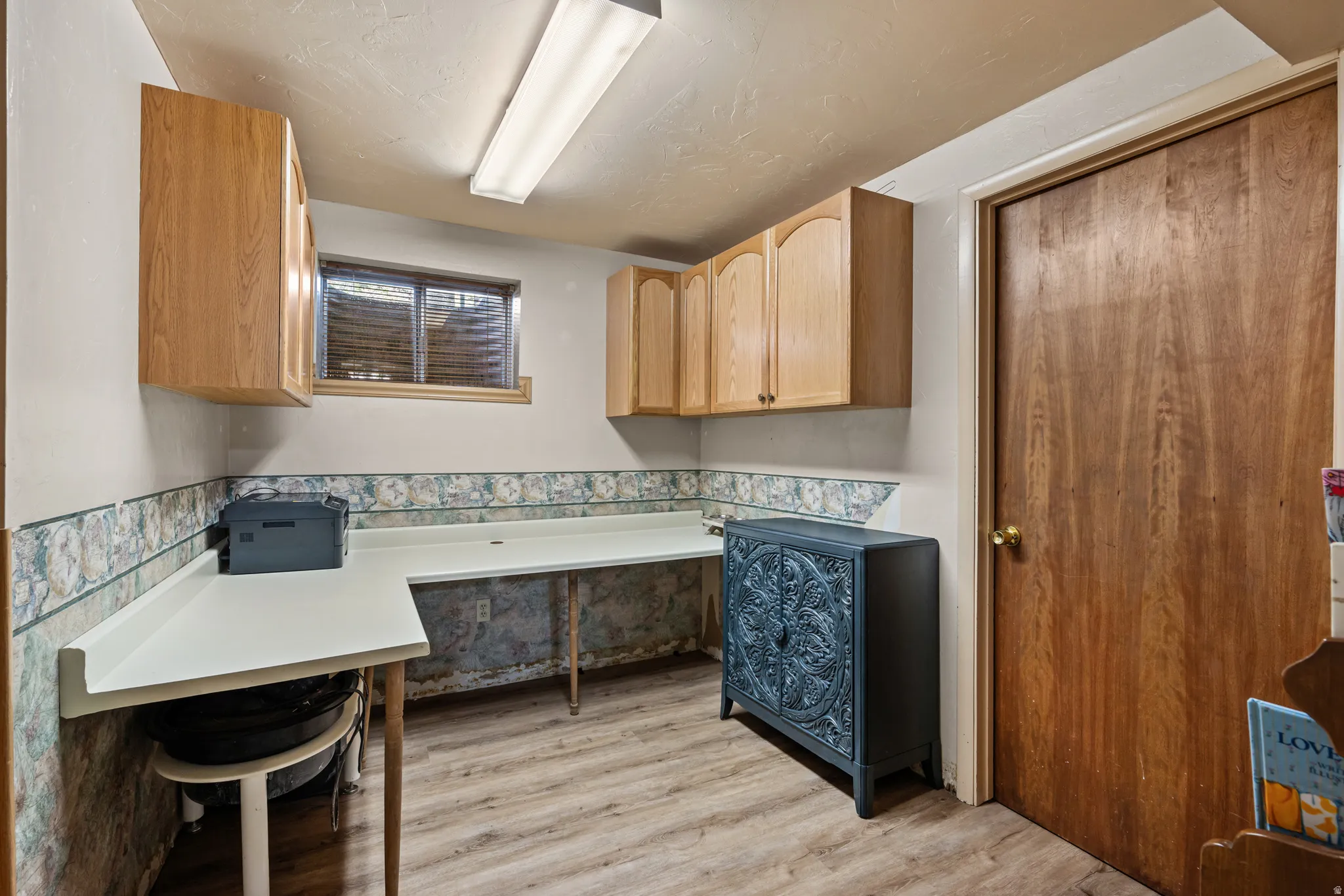 Office space featuring wood-finish flooring and a corner desk surface