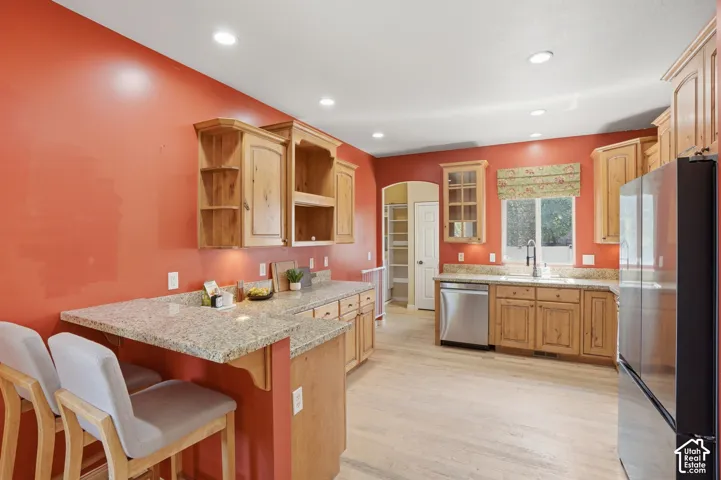 Kitchen featuring light wood cabinetry, recessed lighting, stainless steel appliances (included) and granite countertops