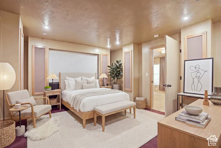Staged for bedroom space. Recessed lighting, wood-finish flooring, light-toned walls, built-in wall panels, and light-toned ceiling