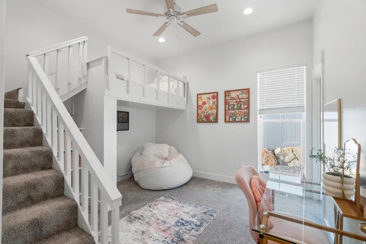 Carpeted staircase with white railings