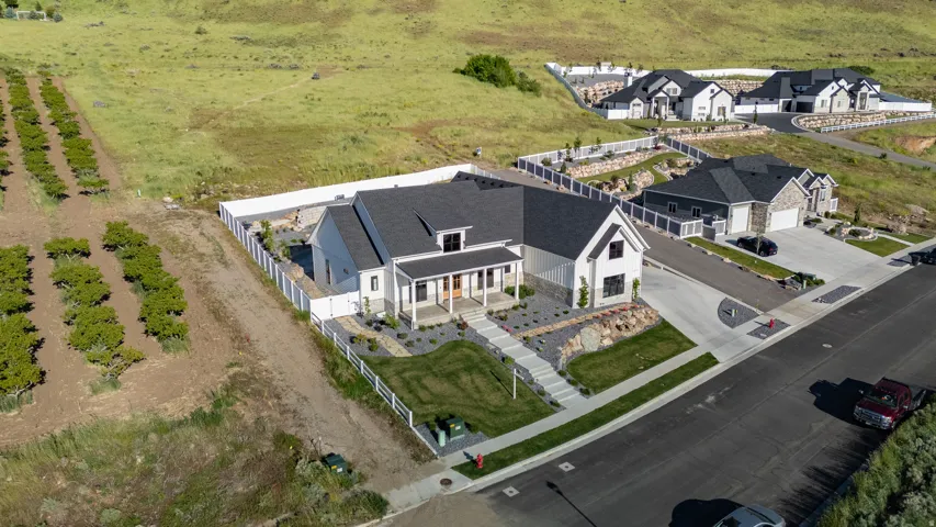 Modern farmhouse-style residence featuring a prominent covered porch and gabled roofline