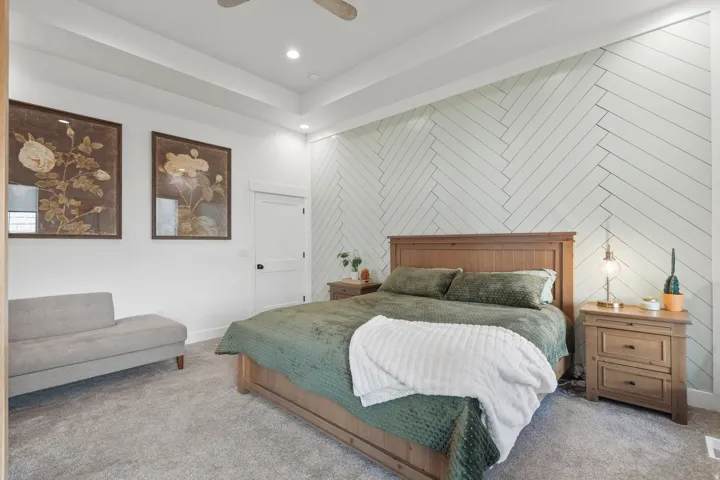 Herringbone accent wall featuring recessed lighting and a tray ceiling