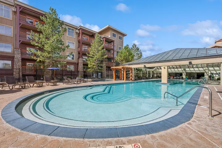 Outdoor swimming pool with integrated steps, surrounded by stamped concrete decking