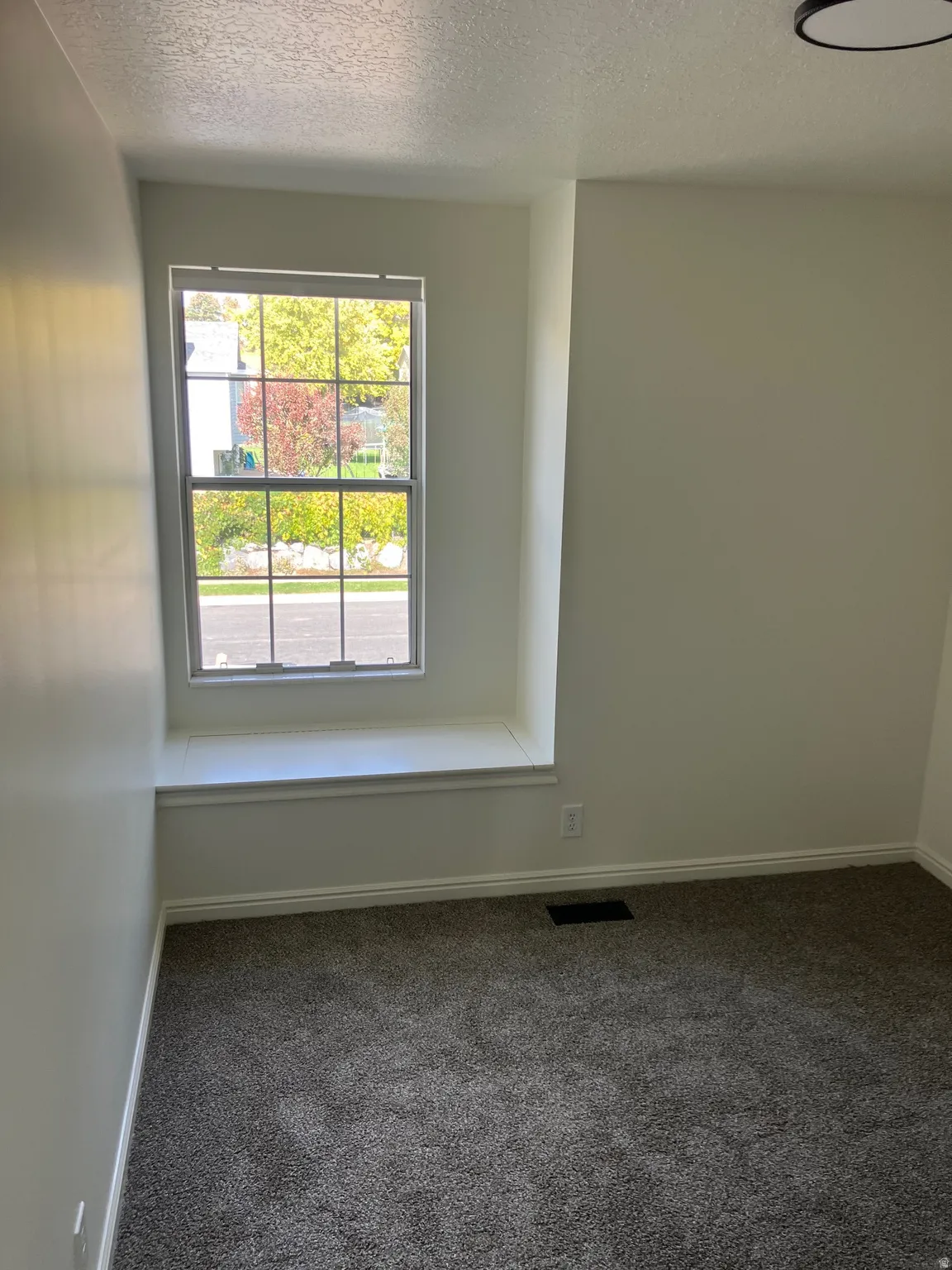 Window seat with white trim and a double-hung window